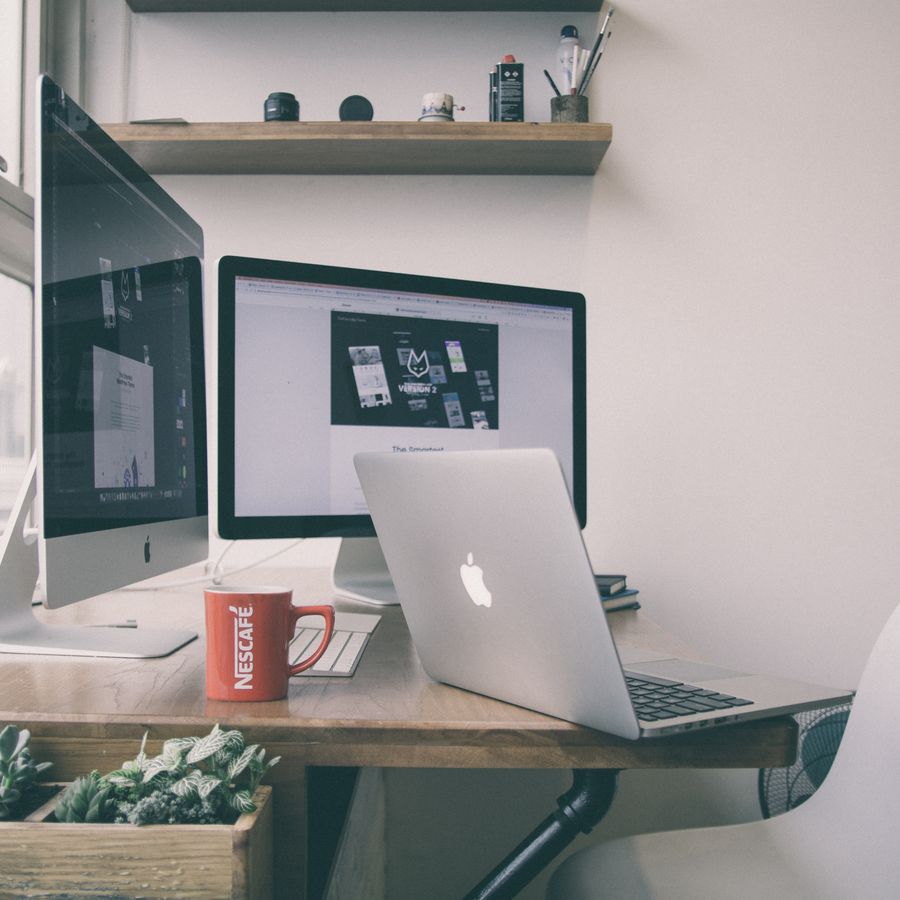 Studio desk with monitors, sketches and design tools