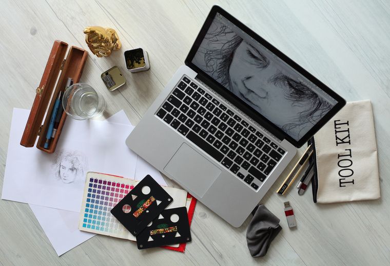 Creative flat lay with sketches, color chart, and tools