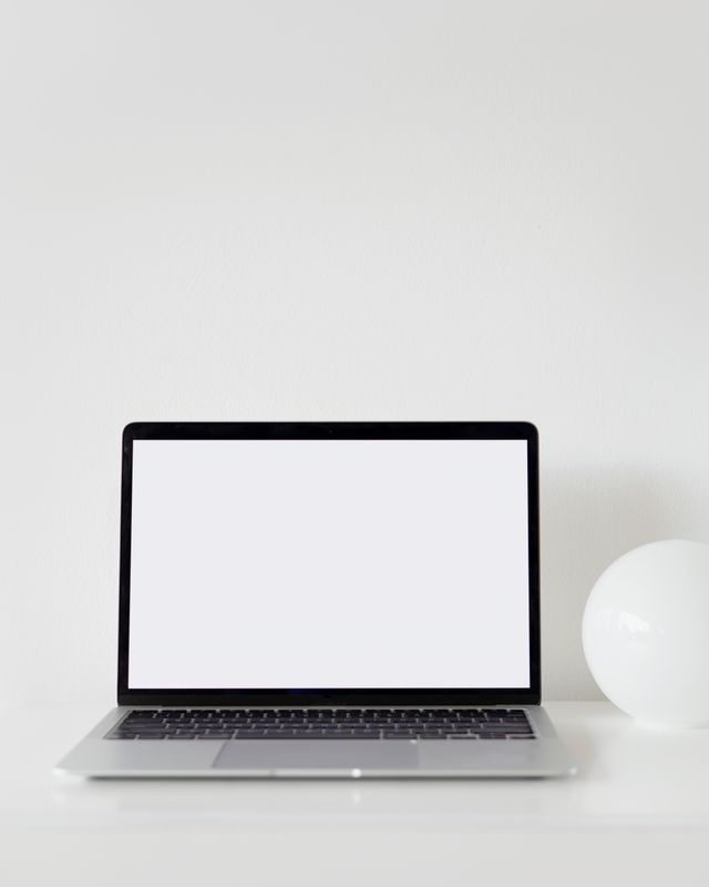 Minimalist laptop with a blank screen on a desk