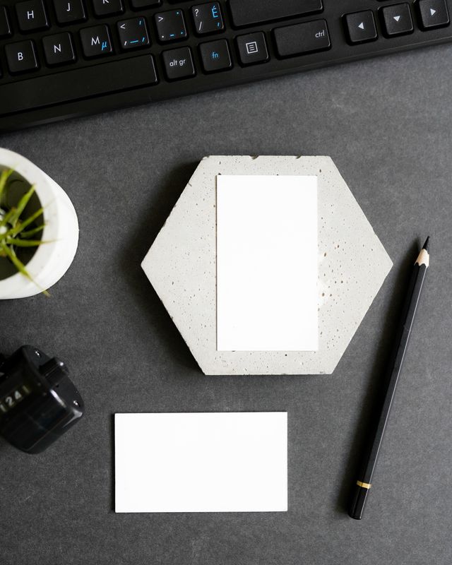 Blank business cards, stationery and a pencil on a desk